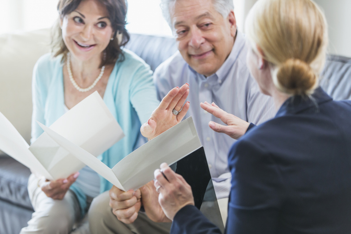 A senior couple meeting with an advisor to create additional retirement income for potential healthcare expenses.